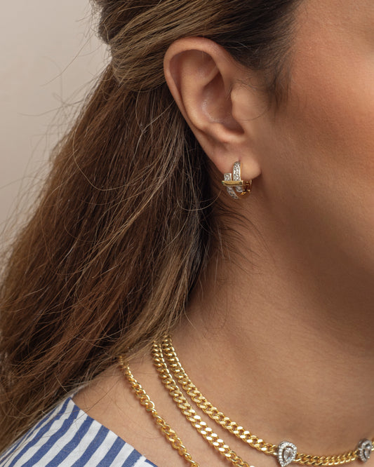 Silver and gold earring.